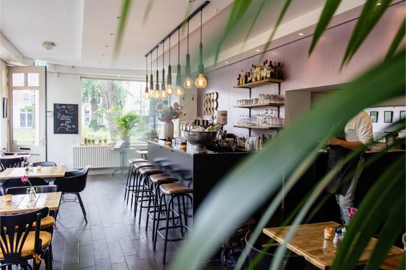 interior shot cafe with chairs near bar with wooden tables 1